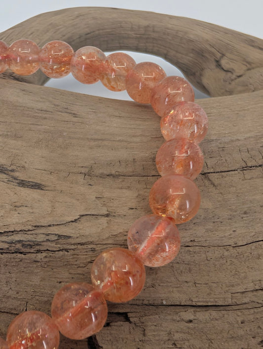 Closeup of Golden Sunstone beads showing coppery shimmer