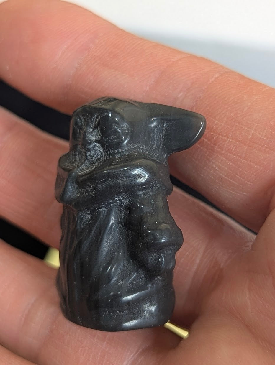Angled rear view of a Gorku totem precision-carved in Black Obsidian.