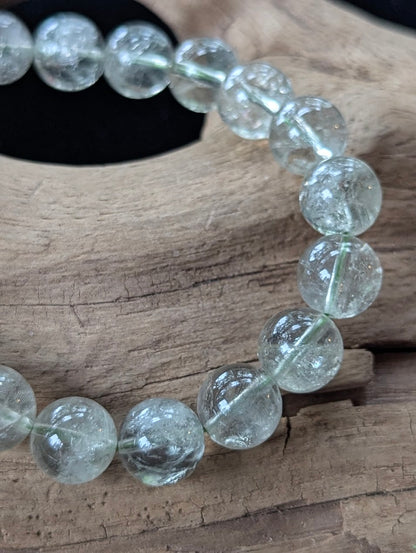 Close-up of 10mm Green Amethyst (Prasiolite) Bracelet, showing high-clarity quartz and internal structure.
