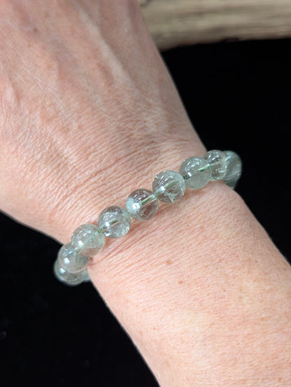10mm Green Amethyst (Prasiolite) Bracelet shown worn on a wrist, illustrating scale and transparency.