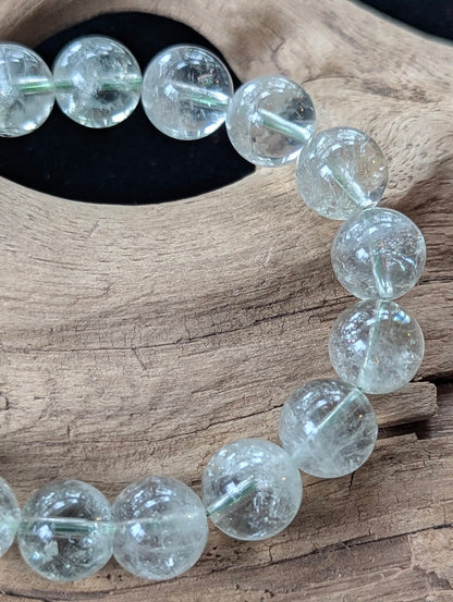 Close-up of 11mm Green Amethyst (Prasiolite) Bracelet, showing high-clarity quartz and internal structure.