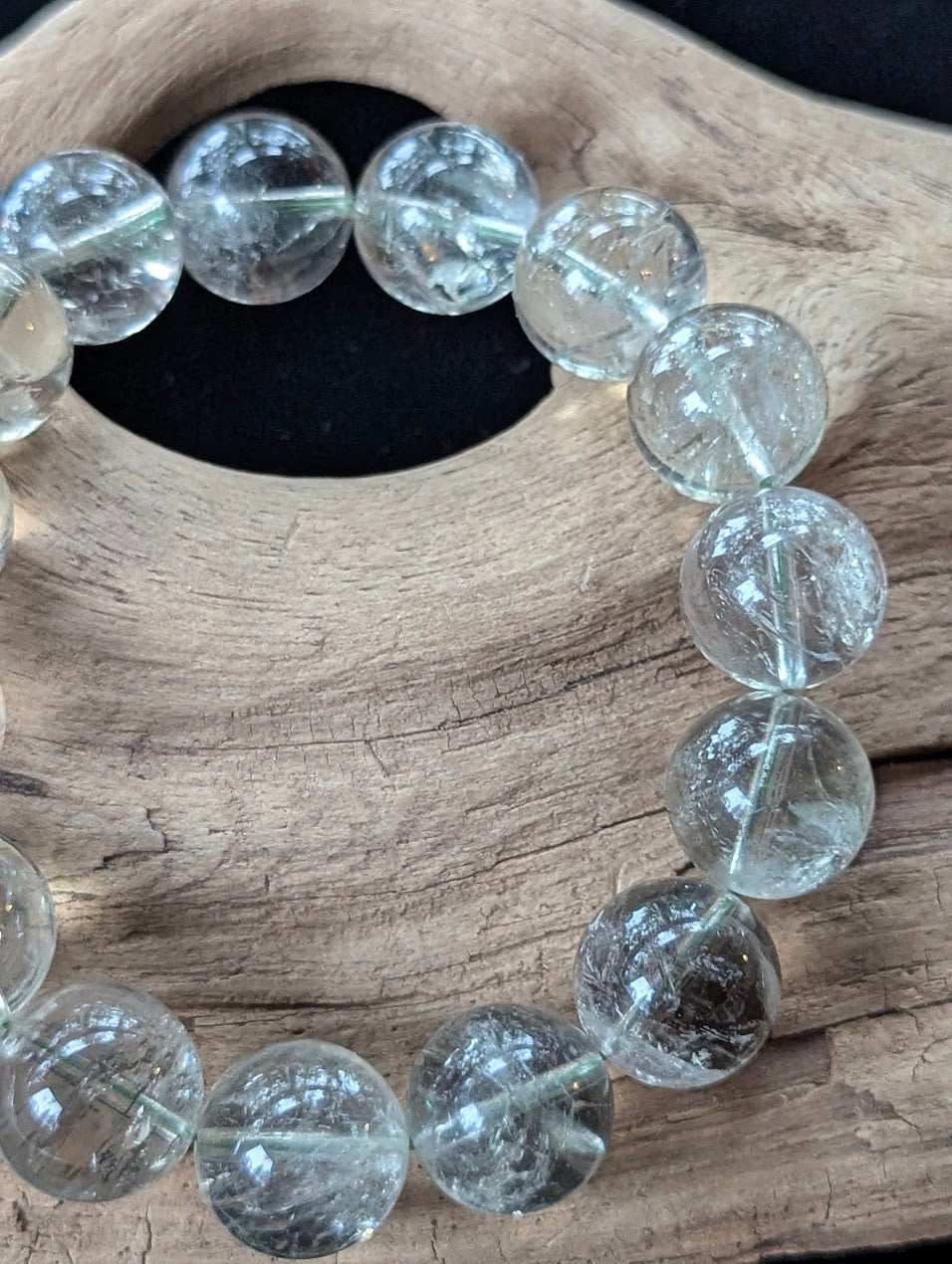 Close-up of 14mm Green Amethyst (Prasiolite) Bracelet, showing high-clarity quartz and internal structure.
