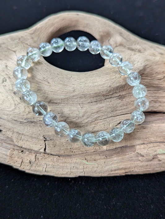 8mm Green Amethyst (Prasiolite) Bracelet, showing pale mint colour and delicate internal inclusions on driftwood.
