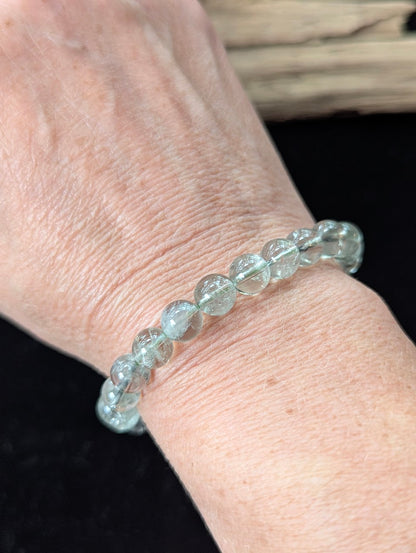 8mm Green Amethyst (Prasiolite) Bracelet shown worn on a wrist, illustrating scale and transparency.