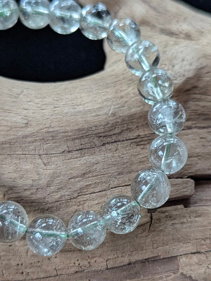 9mm Green Amethyst (Prasiolite) Bracelet, showing pale mint colour and delicate internal inclusions on driftwood.