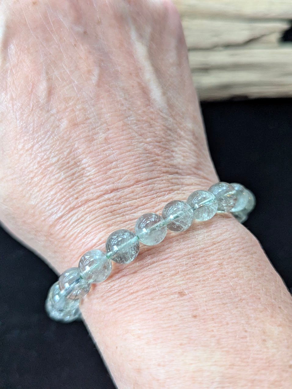 9mm Green Amethyst (Prasiolite) Bracelet shown worn on a wrist, illustrating scale and transparency.