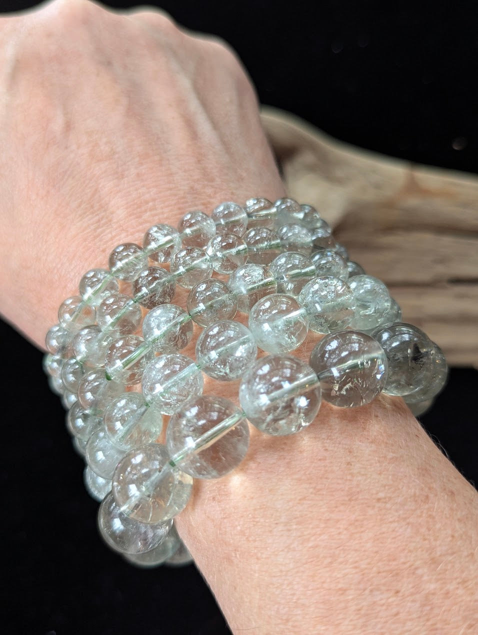 Multiple Green Amethyst (Prasiolite) Bracelets stacked on a wrist, showcasing clarity and scale.