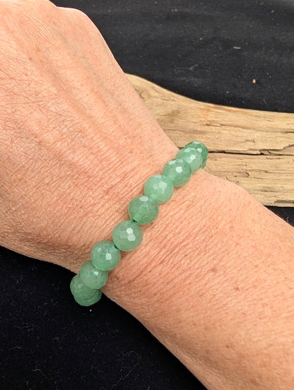 8mm faceted Green Aventurine beaded stretch bracelet worn on a wrist for size scale.