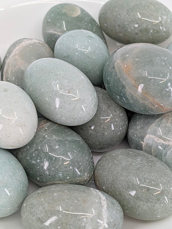 Close-up of Green Aventurine tumbled stones showing fine fuchsite mica shimmer and smooth polished surface