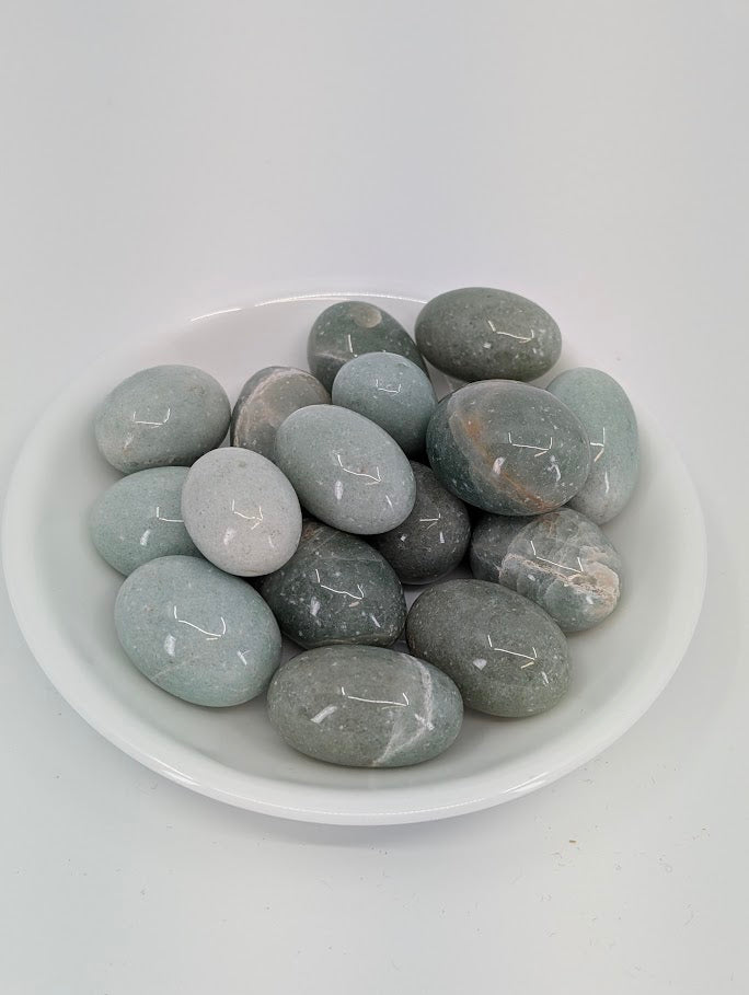 AA grade Green Aventurine tumbled stones displayed in bowl showing even mid-green color and high polish finish