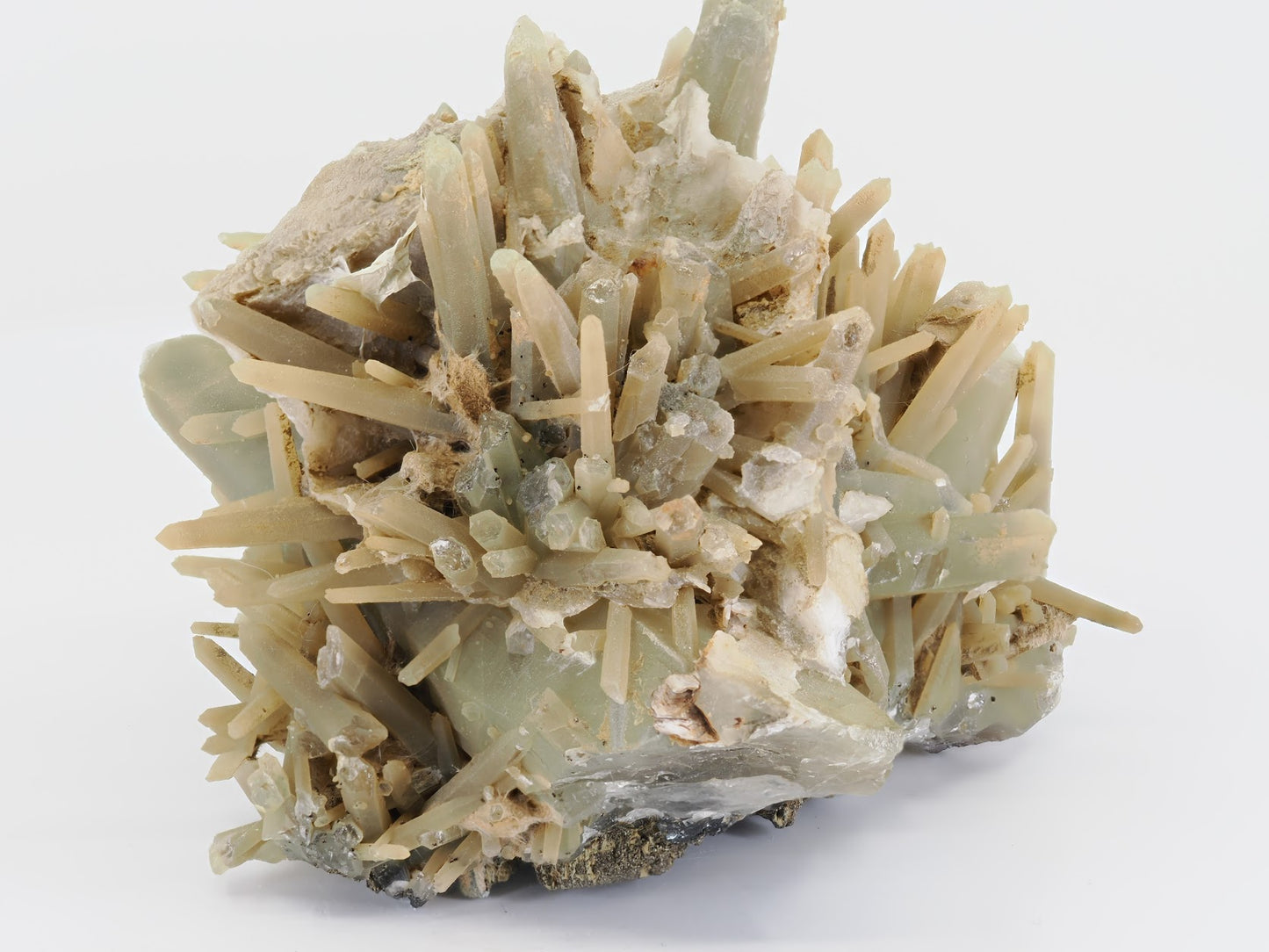Side view of green hedenbergite quartz showing natural matrix connection and crystal depth.