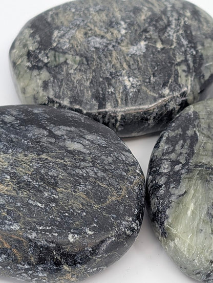 Close-up of polished Green Jade Palm Stone highlighting fibrous texture