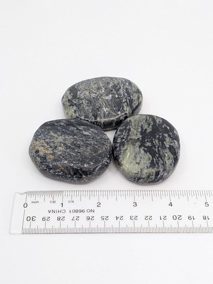 Green Jade Palm Stones beside ruler showing scale