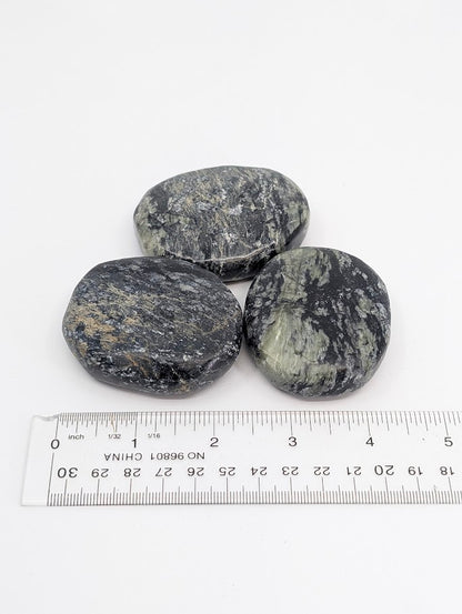 Green Jade Palm Stones beside ruler showing scale