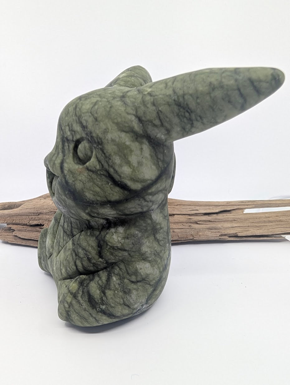 Side profile of an XL Green Jade Pikachu figurine highlighting its detailed tail and mossy green color.