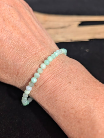 3mm faceted Green Opal beaded stretch bracelet worn on a wrist for delicate size scale.