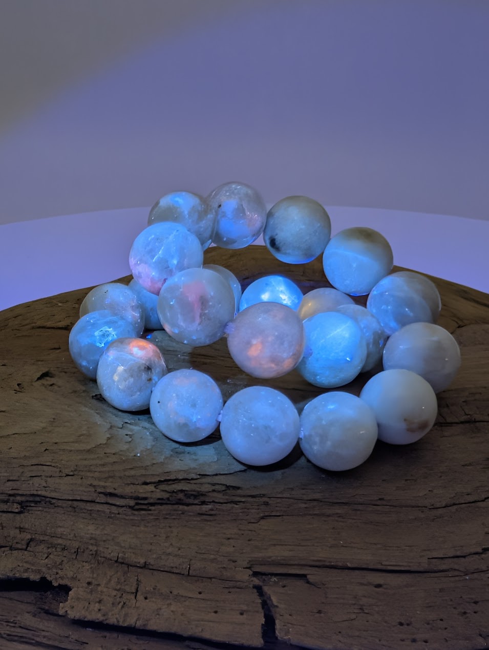 8mm hackmanite bracelet glowing blue and pink under UV black light