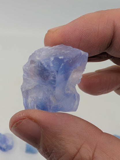 Blue halite crystal with textured raw halite surfaces