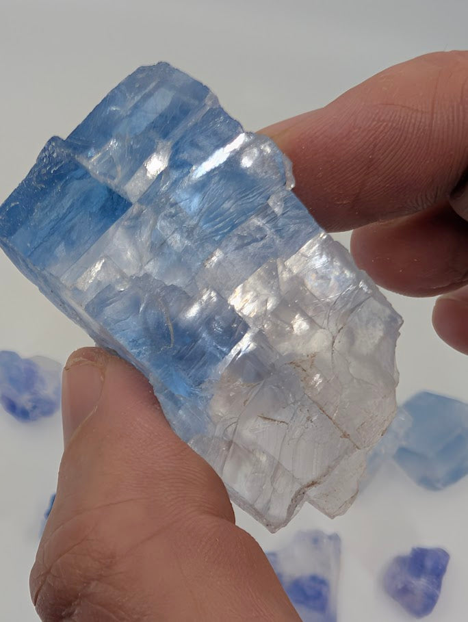 Blue halite crystal with striking zones and raw halite texture