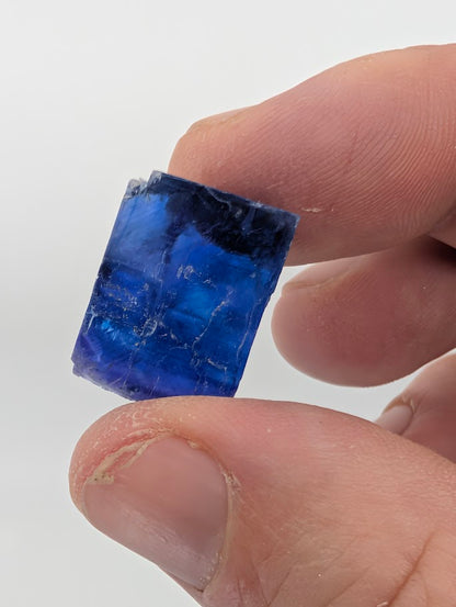 Tiny gem-like blue halite crystal with sharp color core