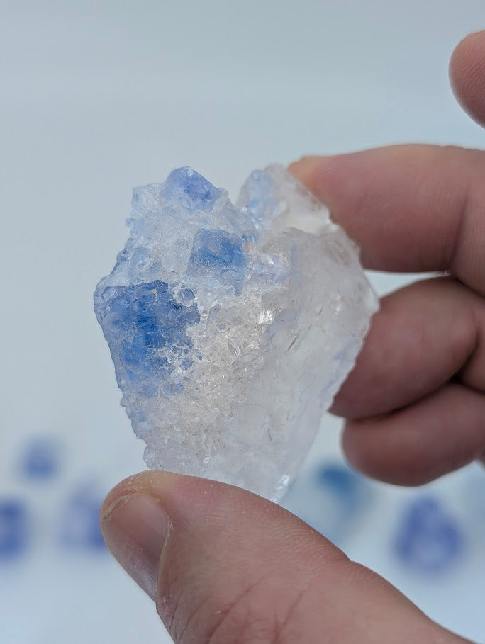 Natural halite crystal with soft blue coloring and visible cleavage