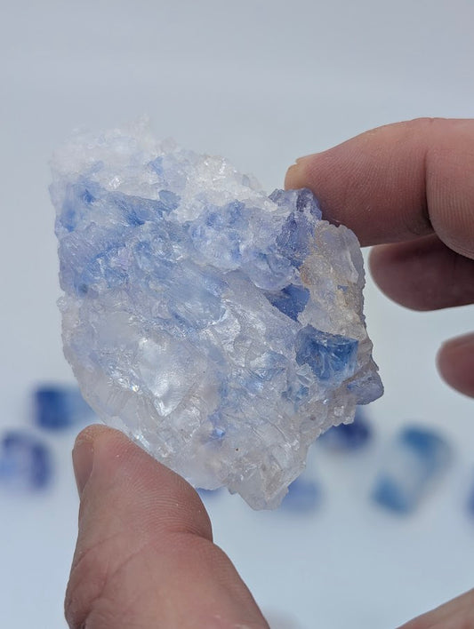 Raw halite crystal with blue inclusions and evaporite texture