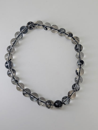 Top-down view of 6.8mm HQ Herkimer style quartz bracelet