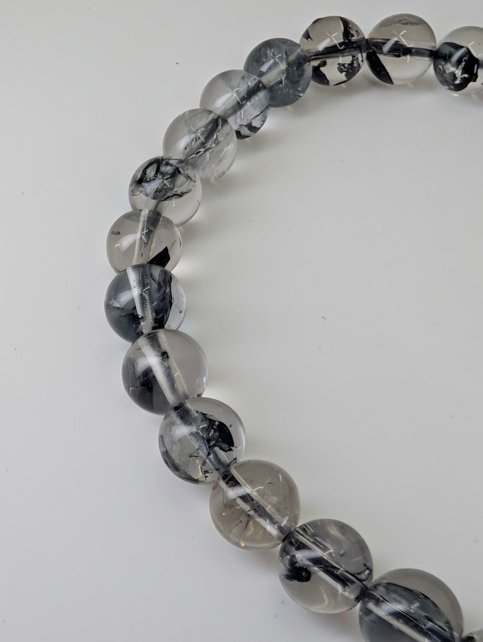 Close-up photo of polished quartz beads highlighting mirror finish