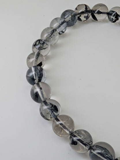 Close-up photo of polished quartz beads highlighting mirror finish