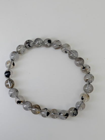 Flat lay of Herkimer style quartz bracelets highlighting clear quartz beads
