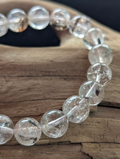 Macro detail of 11mm Himalayan Garden Quartz beads capturing the pristine quartz matrix and earth-toned internal inclusions.