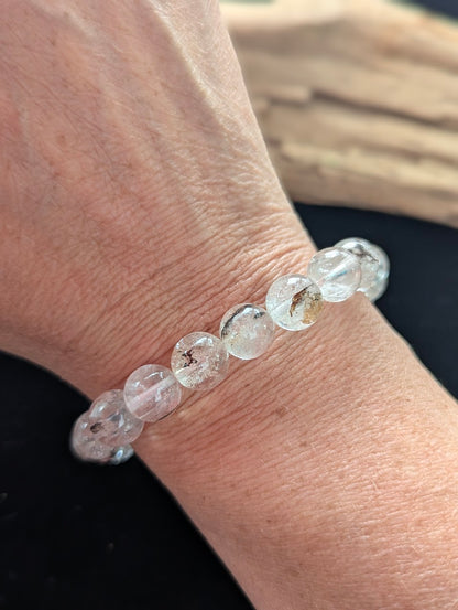 11mm AAA Grade Himalayan Garden Quartz beaded stretch bracelet worn on a wrist in natural sunlight.