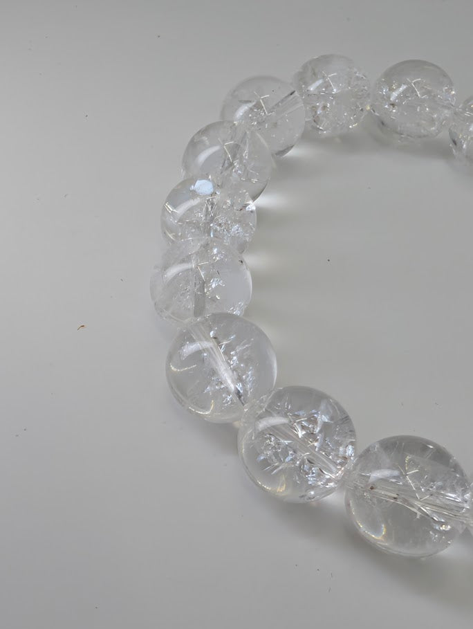 12mm Himalayan clear quartz bracelet with high polish and internal rainbows