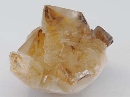 Top-down view of amber Honey Calcite showing distinct rhombohedral crystal zoning and vitreous luster.