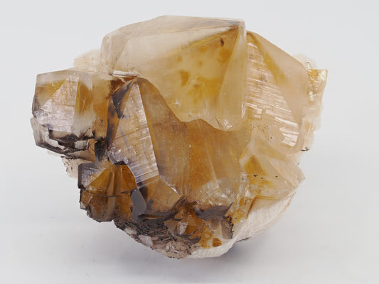 Front view of golden Honey Calcite cluster with dark "Chocolate" Sphalerite inclusions from China.
