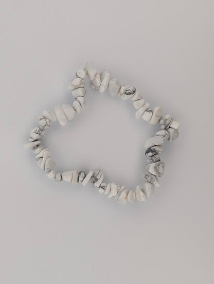 Overhead view of Howlite chip bead stretch bracelet on white background