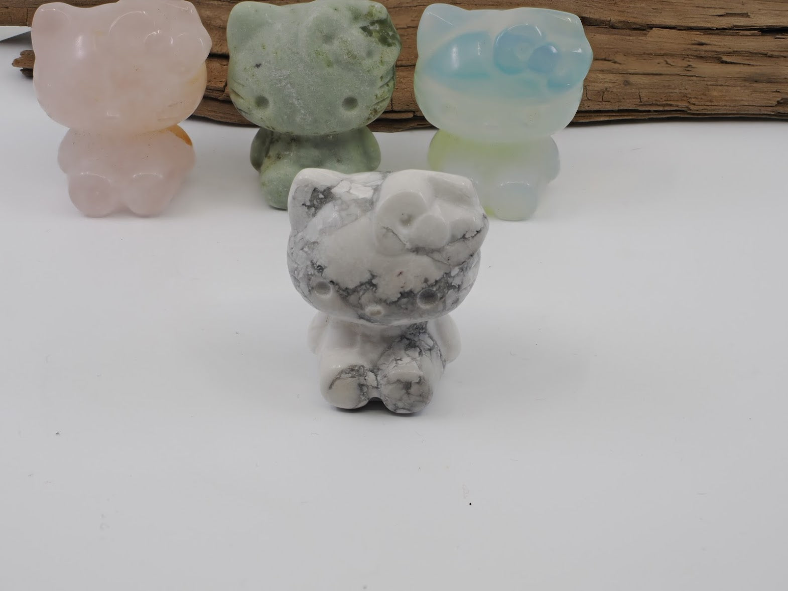 Close-up of a hand-carved Howlite Hello Kitty figurine showing distinctive natural grey web-like veining on a white mineral base.