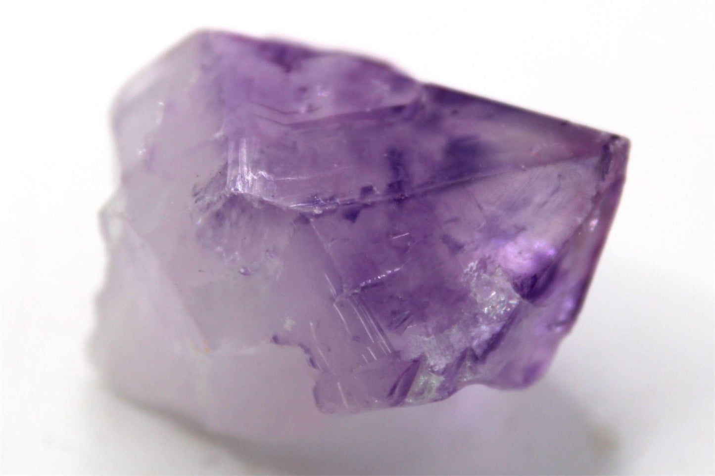 Natural Raw Amethyst Crystal Point with inclusions and Rainbow, from Brazil. Approx. 4.5 cm x 3.5 cm