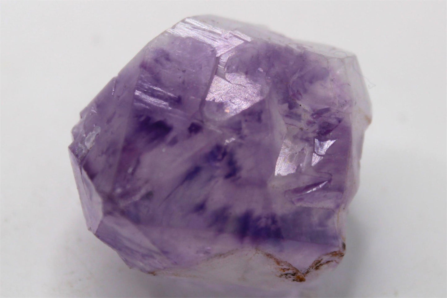 Natural Raw Amethyst Crystal Point with inclusions and Rainbow, from Brazil. Approx. 4.5 cm x 3.5 cm