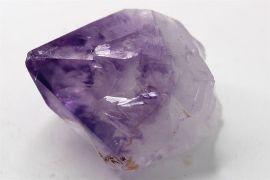 Natural Raw Amethyst Crystal Point with inclusions and Rainbow, from Brazil. Approx. 4.5 cm x 3.5 cm