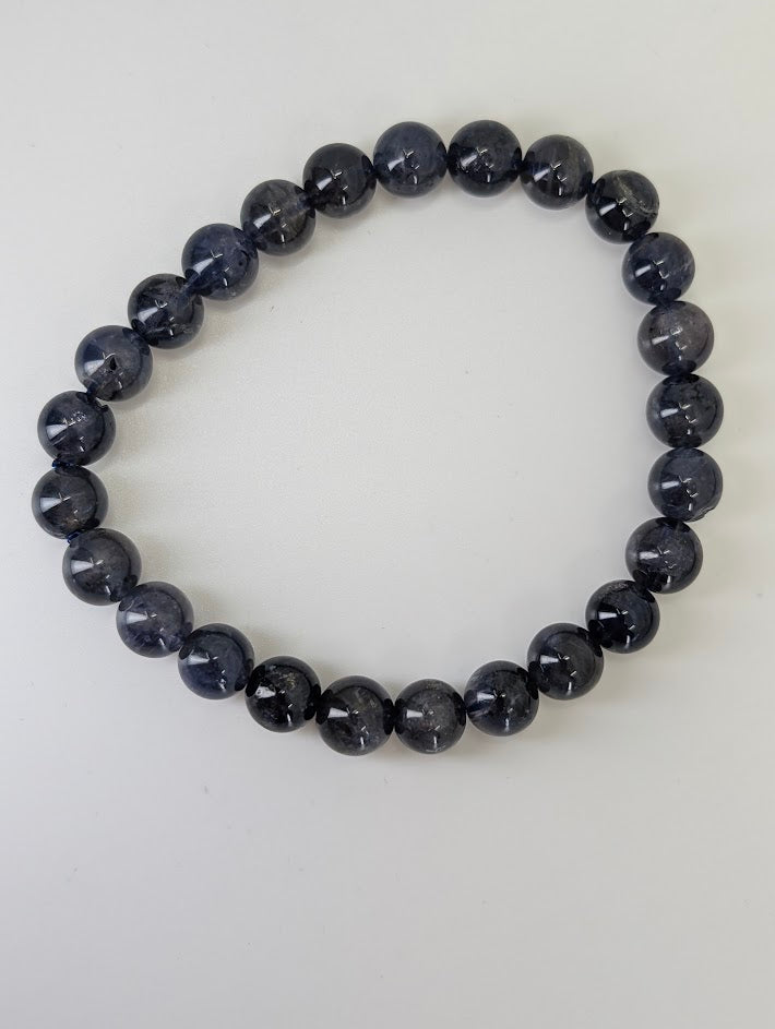 Detailed view of natural iolite beads showing inclusions and sheen