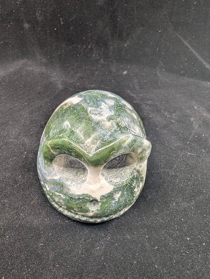 Top view of Moss Agate Jack Skellington carving showing green dendritic “moss” inclusions and glossy polish