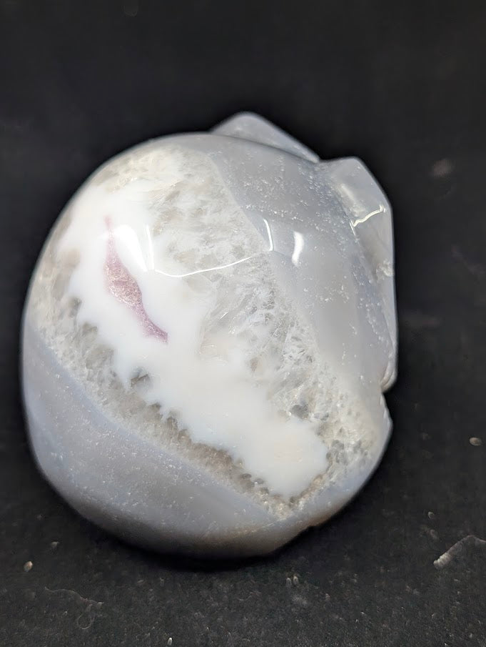 Detail of Ocean Agate Jack Skellington carving showing soft grey banding and glossy polish back side view