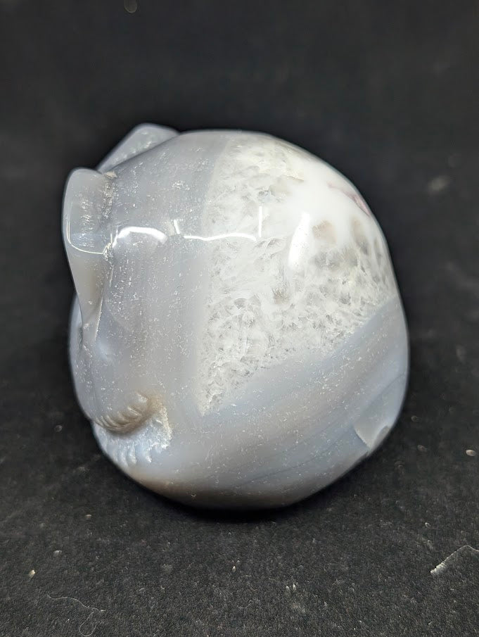 Detail of Ocean Agate Jack Skellington carving showing soft grey banding and glossy polish side view