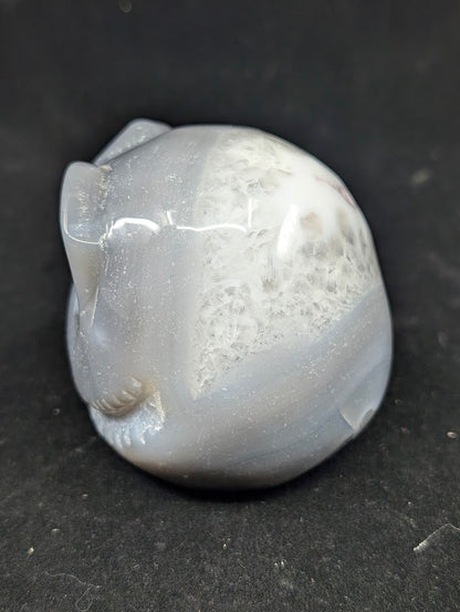 Detail of Ocean Agate Jack Skellington carving showing soft grey banding and glossy polish side view
