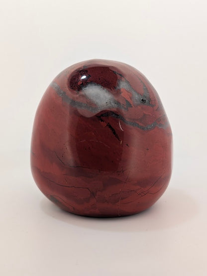 Detail of Red Jasper Jack Skellington carving showing rich red tones and natural veining of side 1