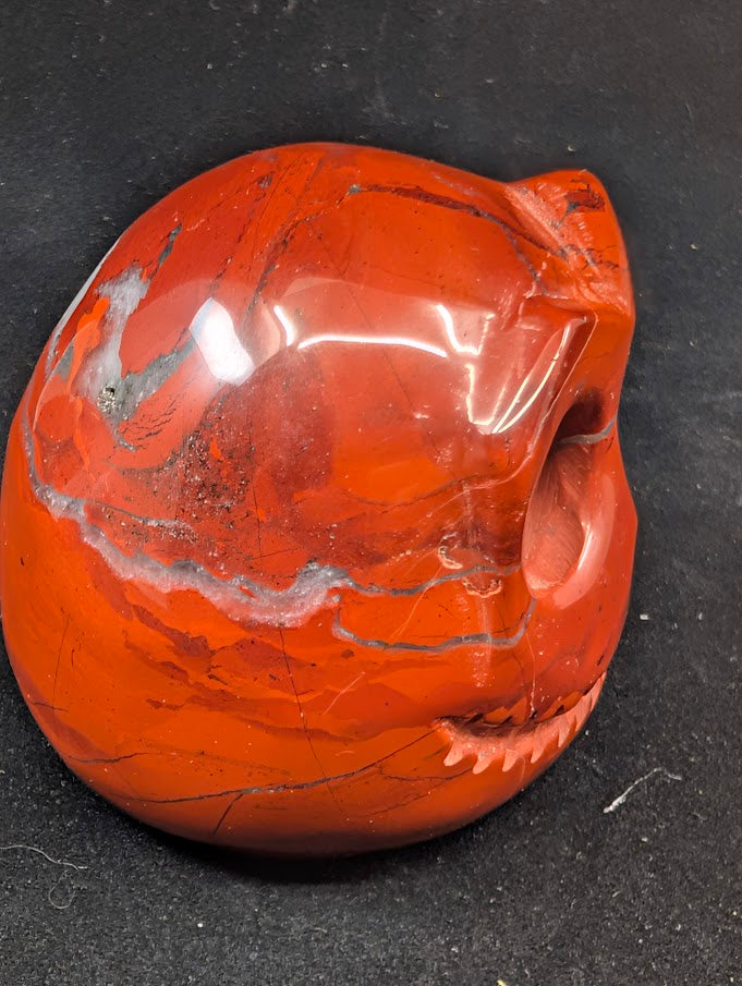 Detail of Red Jasper Jack Skellington carving showing rich red tones and natural veining of side 1