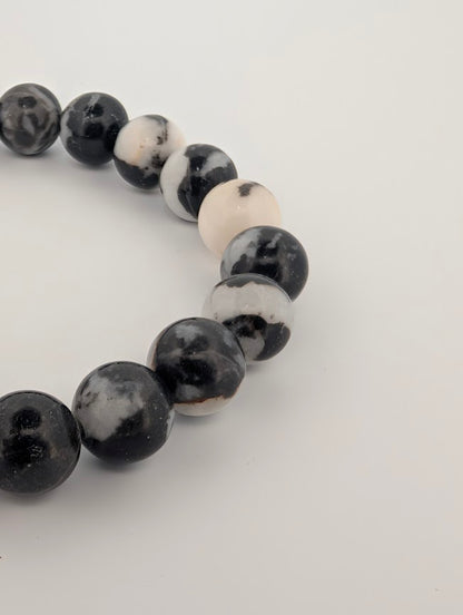 Angled close-up highlighting natural contrast and pattern in Zebra Jasper beads