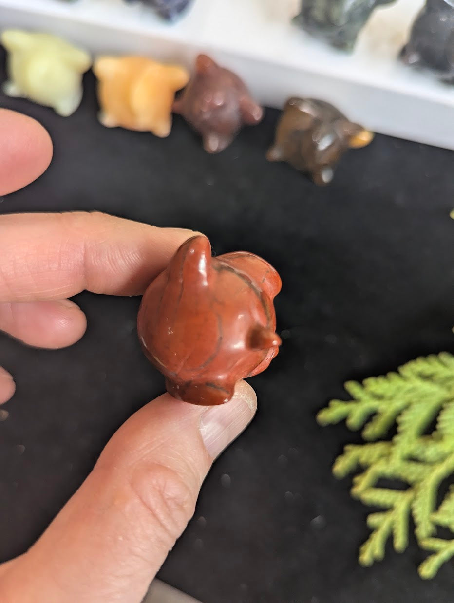 Top down view of a Red Jasper Jigglypuff highlighting the signature carved curl.