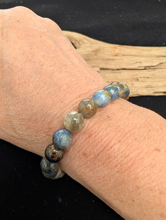 8mm smooth Kyanite beaded stretch bracelet worn on a wrist for size scale.